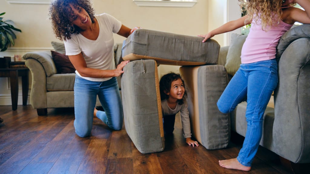 Image of a family at the table or in their living room with a hardwood floor