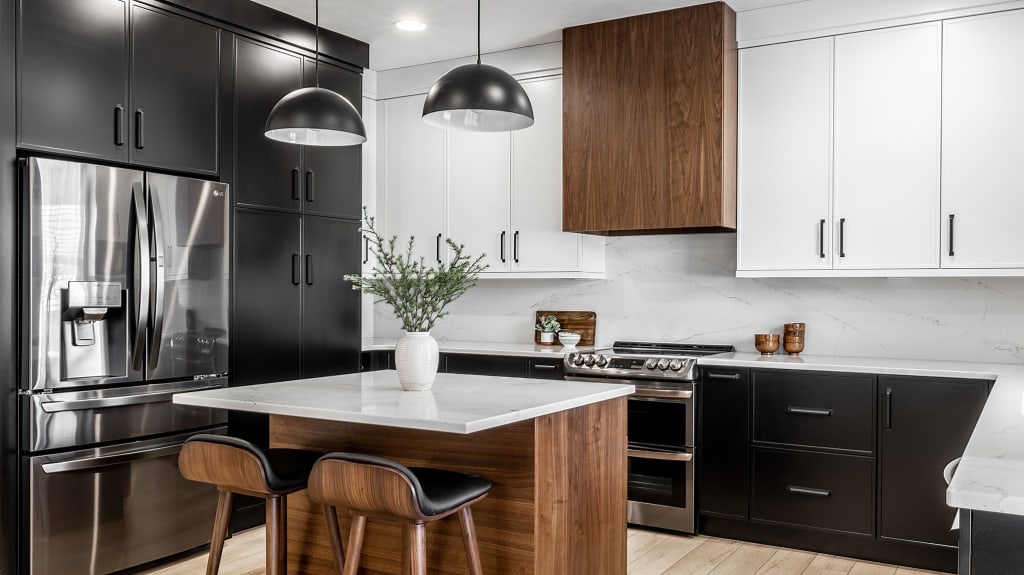 Renovated kitchen with white thermoplastic cabinets, quartz countertop and luxury vinyl flooring in Quebec