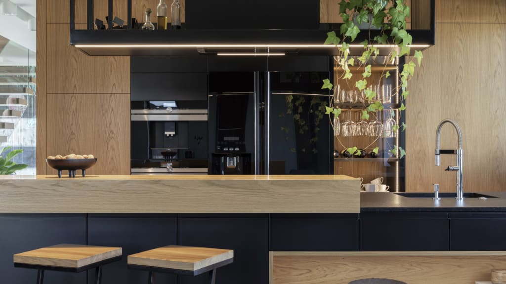 Minimalistic modern wooden panel kitchen interior with ergonomic biuld-in kitchen and kitchen island