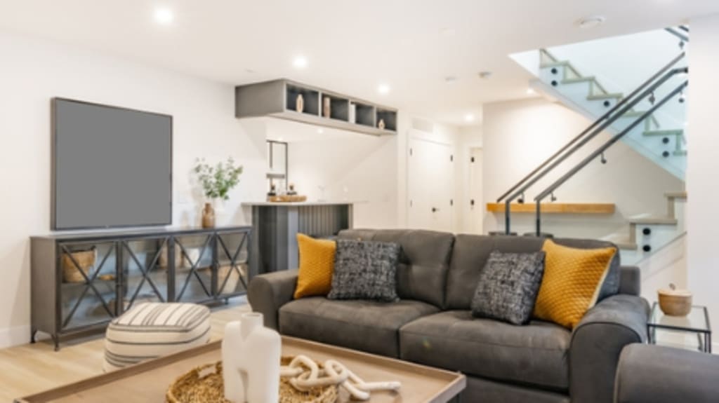 basement with recessed lighting and grey couches