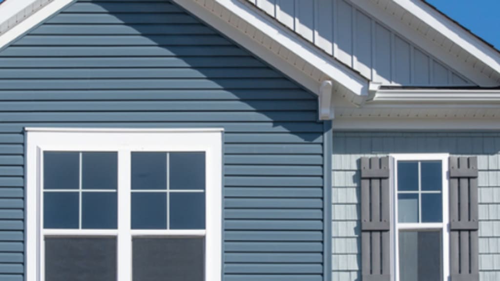 home with blue siding and square windows