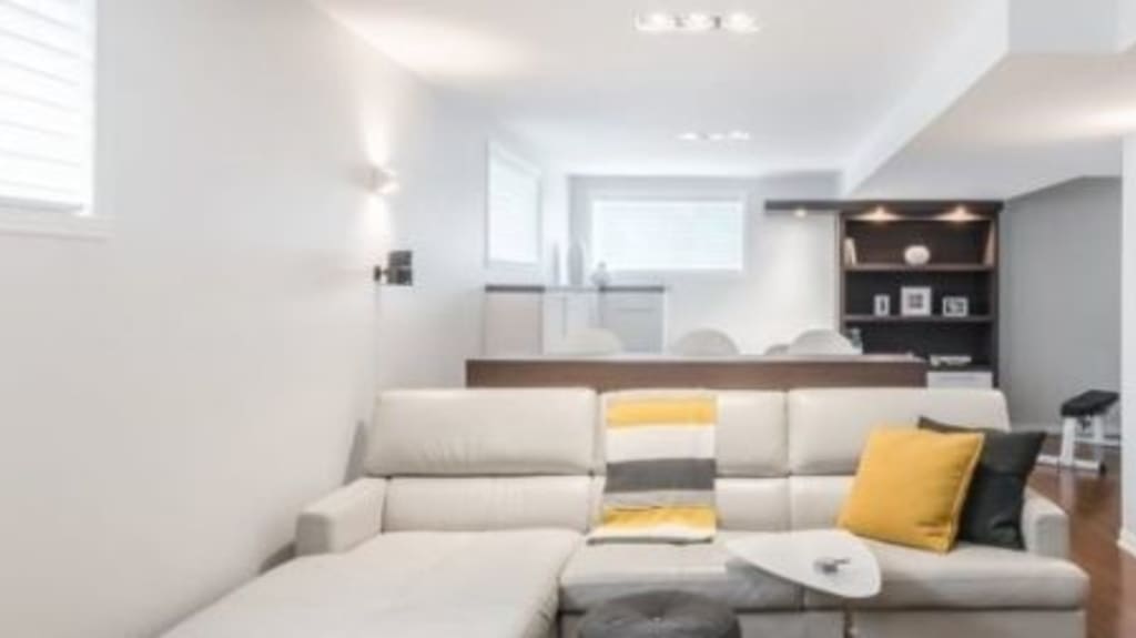 bright renovated basement with sectional sofa