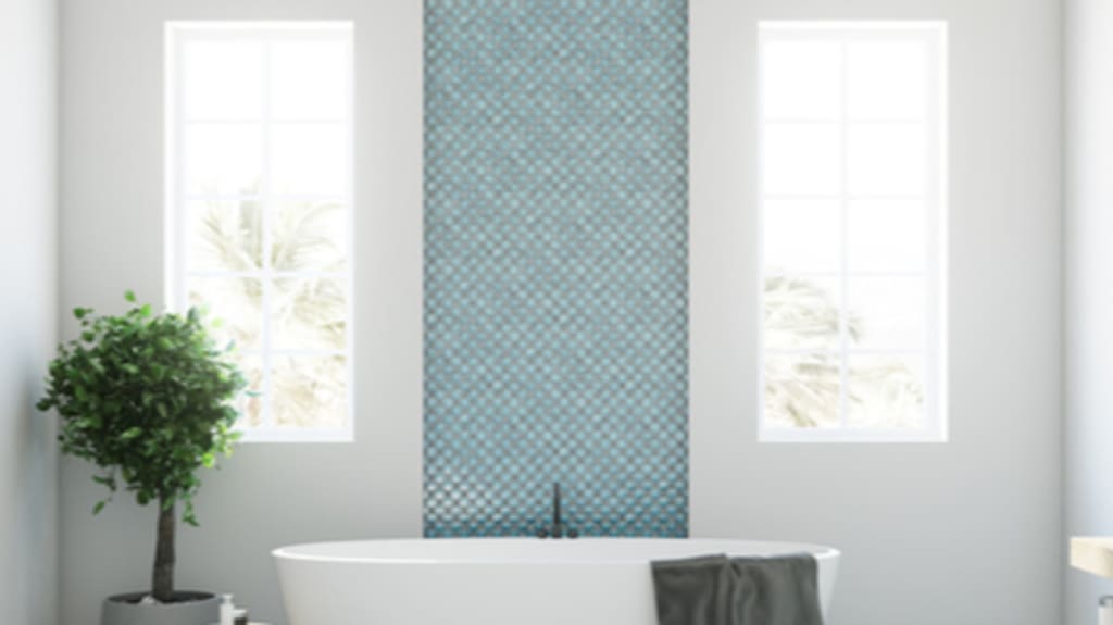 bathroom blue wall tiles and freestanding tub with interior tree