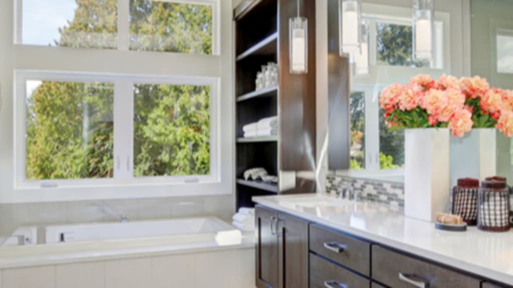 contemporary bathroom with recessed bath under large window