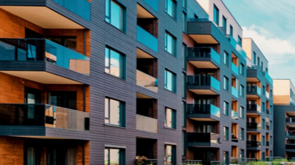 modern condo building with large balconies and sidewalk