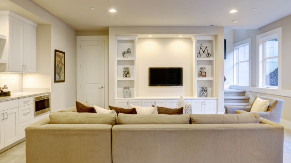finished contemporary basement with built it media center and wet bar