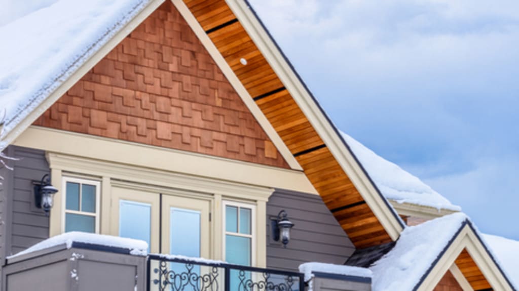 rooftop of beautiful winter home with windows and balcony