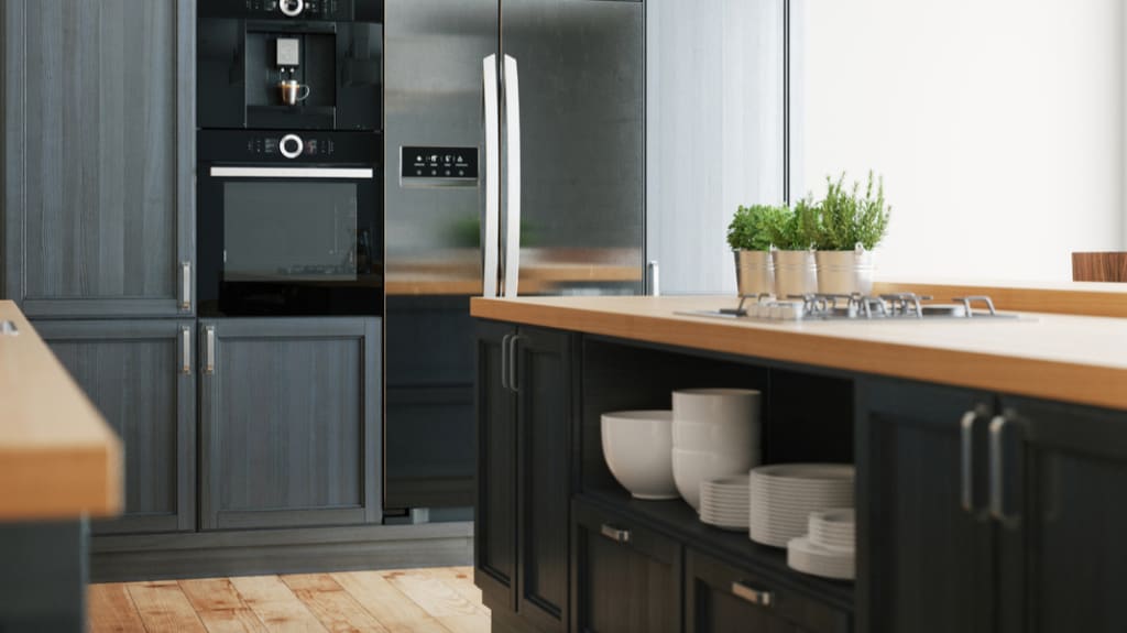 modern kitchen with dark grey cabinets and wood countertops