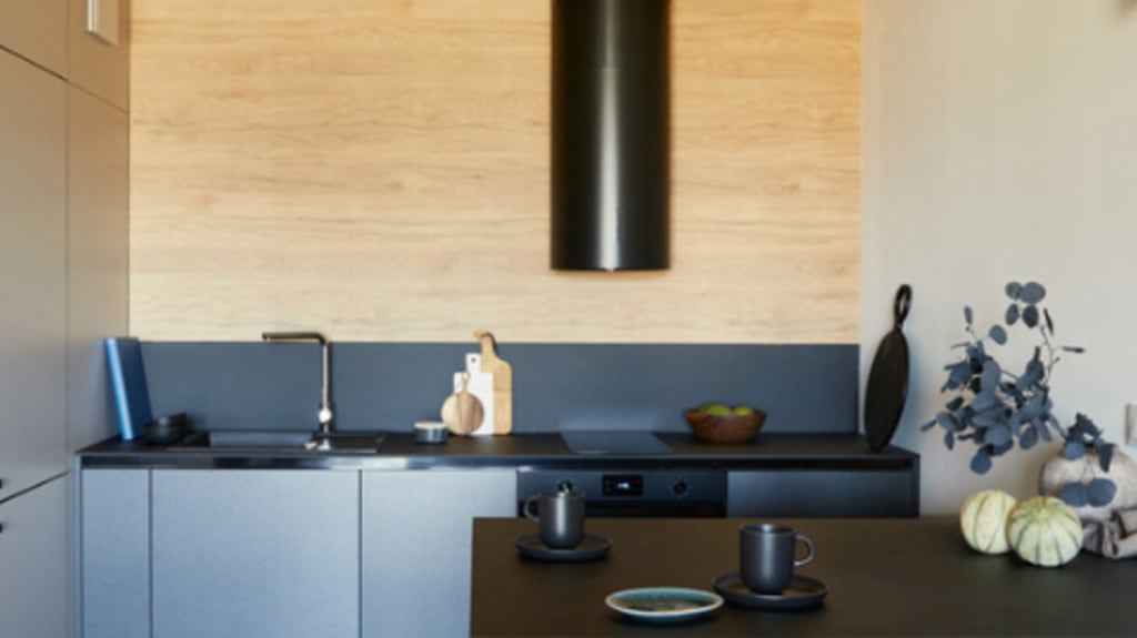 optimized kitchen with blue cabinets and wood backsplash