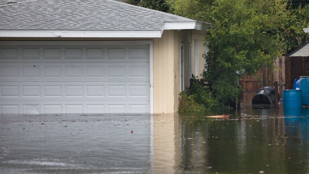 Exterior courtyard and house flooded following torrential rains