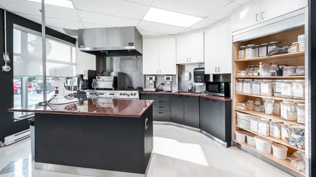 Renovated industrial kitchen with central island and cooking appliances