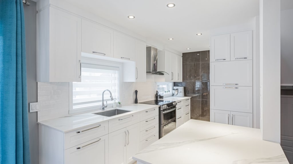 open concept space with living room and white kitchen