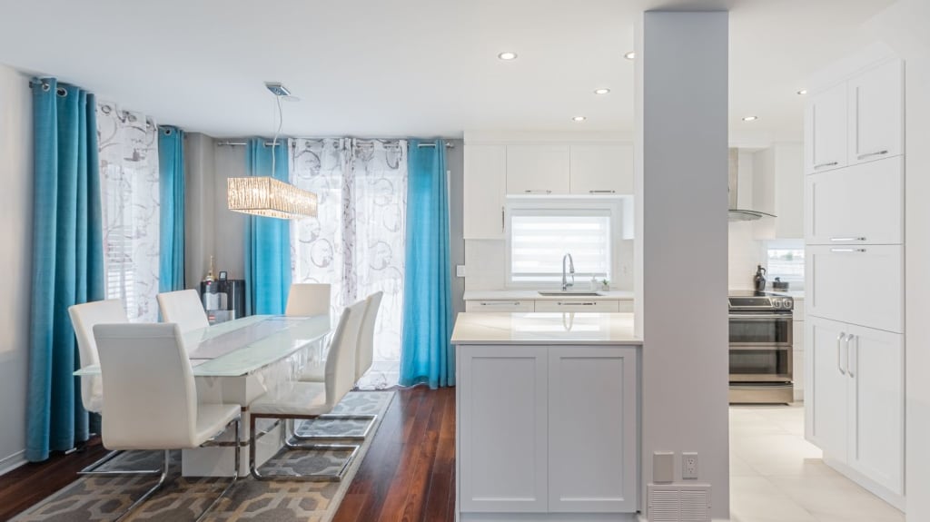open concept space with living room and white kitchen