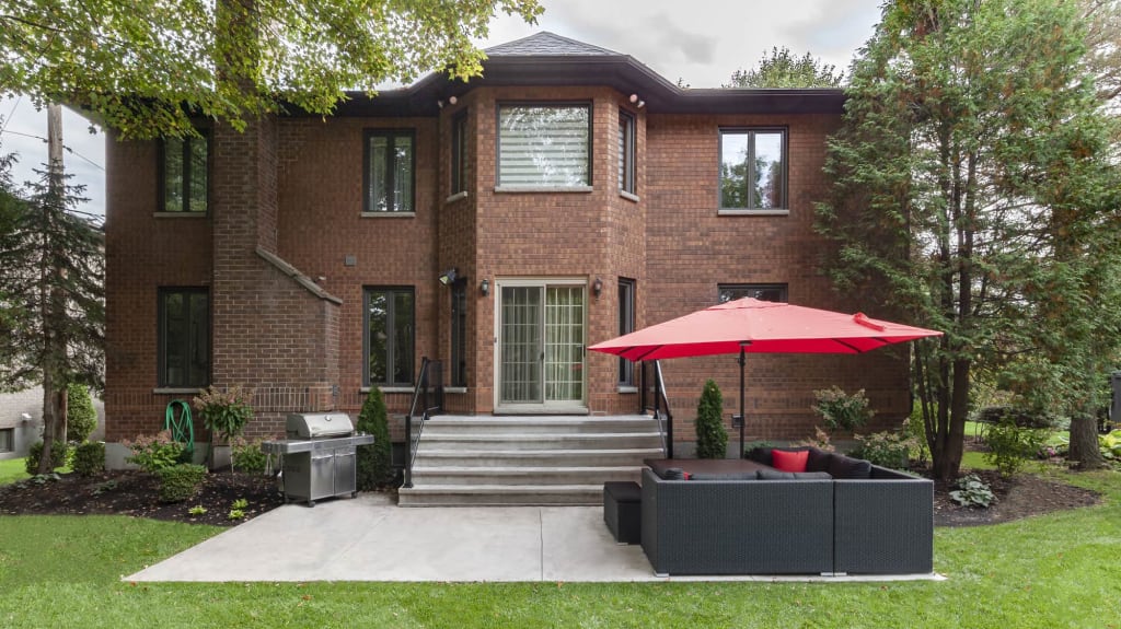 concrete terrace and stairs - back of a brick house