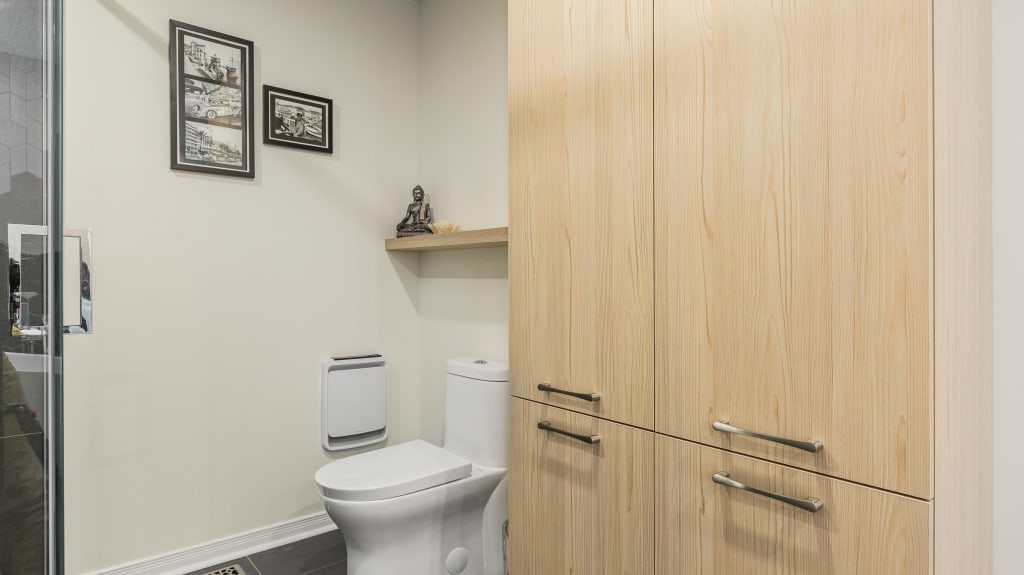 The mix of light wood cabinets paired with varying shades of grey and black provides contrast that’s as timeless as it is unique.  