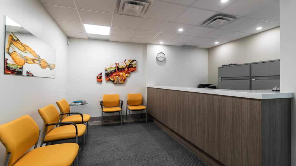Renovated waiting room with yellow chairs - Stimula Physiotherapy Clinic