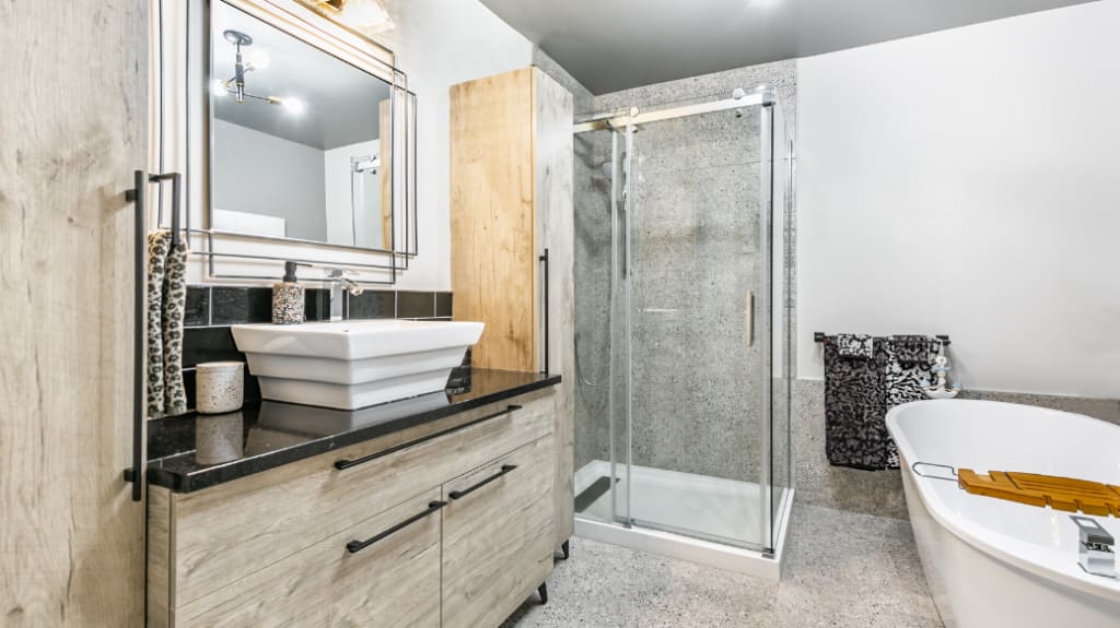 Renovated industrial bathroom with taupe vanity