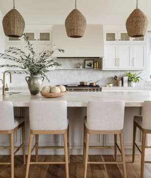 Bright kitchen in shades of white, beige and cream, including oversized plaster hood