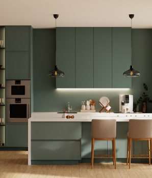 Modern kitchen with green furniture and white worktop, minimalist pendant lamps and light brown armchairs