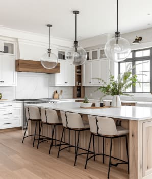 Trio of spherical lights above a white oak kitchen island in a farmhouse decor