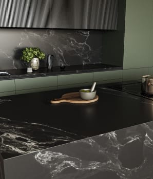 Dark green kitchen with black marble island