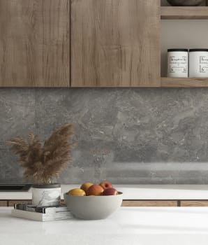 Wooden cabinets and gray stone backsplash