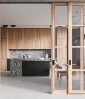 Elegant kitchen behind glass doors with grey concrete floor