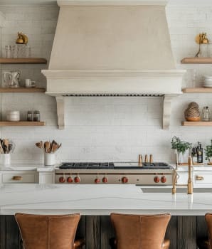 Organic kitchen with white stone wall, built-in plaster hood and open shelves