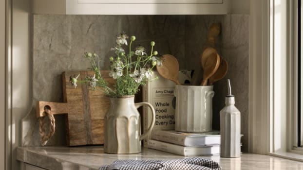 Wooden display board and ceramic pots on kitchen countertop
