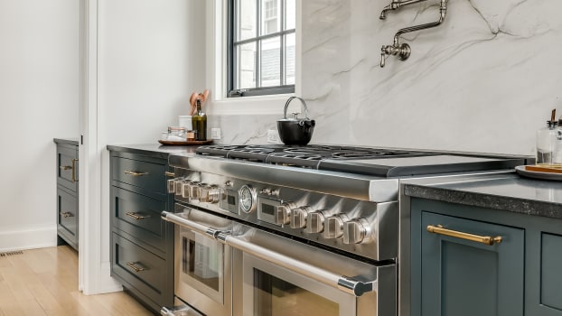 Marble wall design in a kitchen with luxury stainless steel appliances