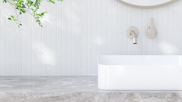 Lavabo rectangulaire sur comptoir de vanité de salle de bain en marbre devant du carrelage blanc