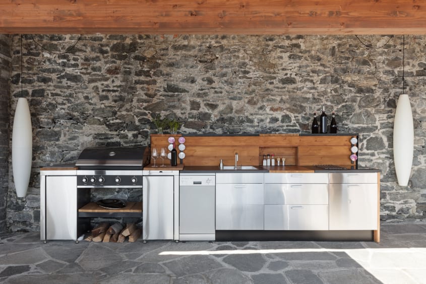 Stone veranda with stainless steel outdoor kitchen setup