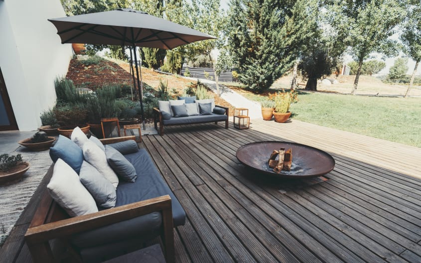 Wooden deck with furniture and potted plants
