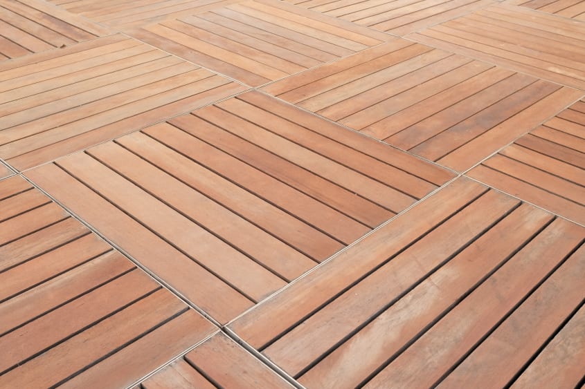 Zoomed in look at mosaic flooring wooden tiles of a deck