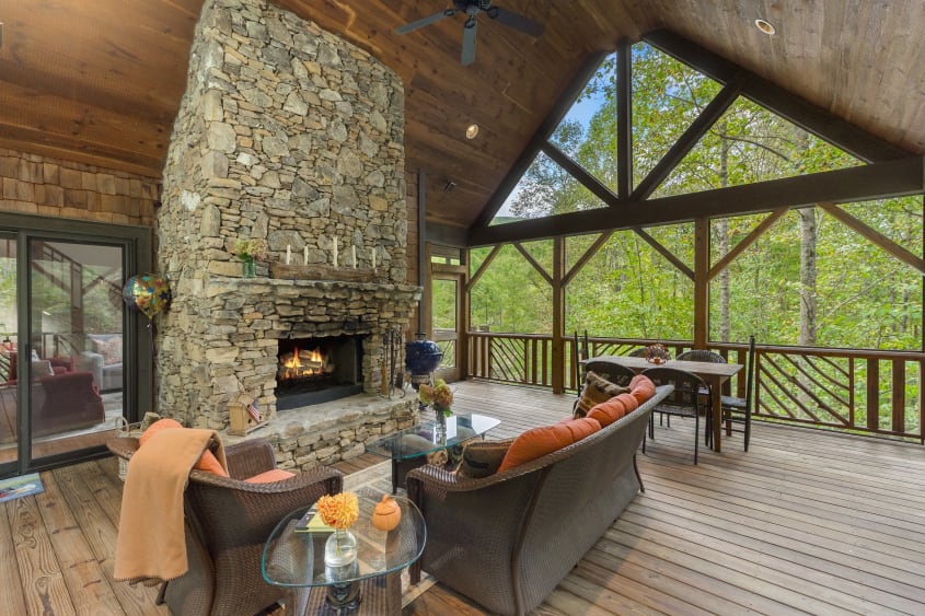 A-frame cabin with covered porch and built-in fireplace