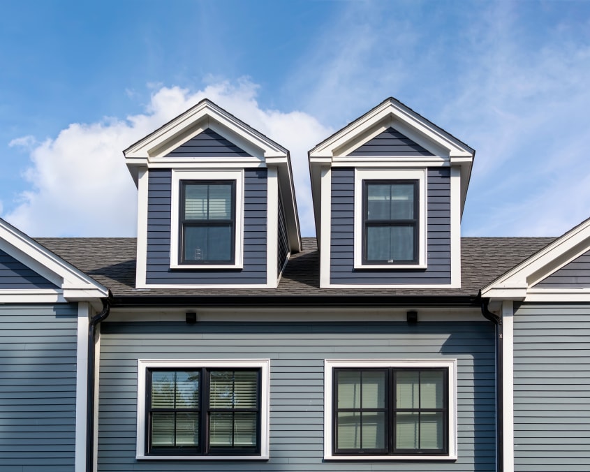 Close up view of gray/blue home with aluminum siding