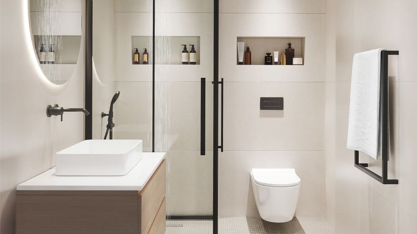 Douche vitrée, murs clairs avec niches intégrées, toilette suspendue et meuble-lavabo en bois clair