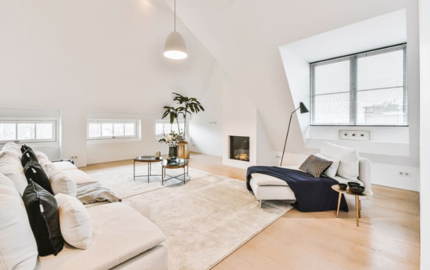loft in attic with sofa and fireplace