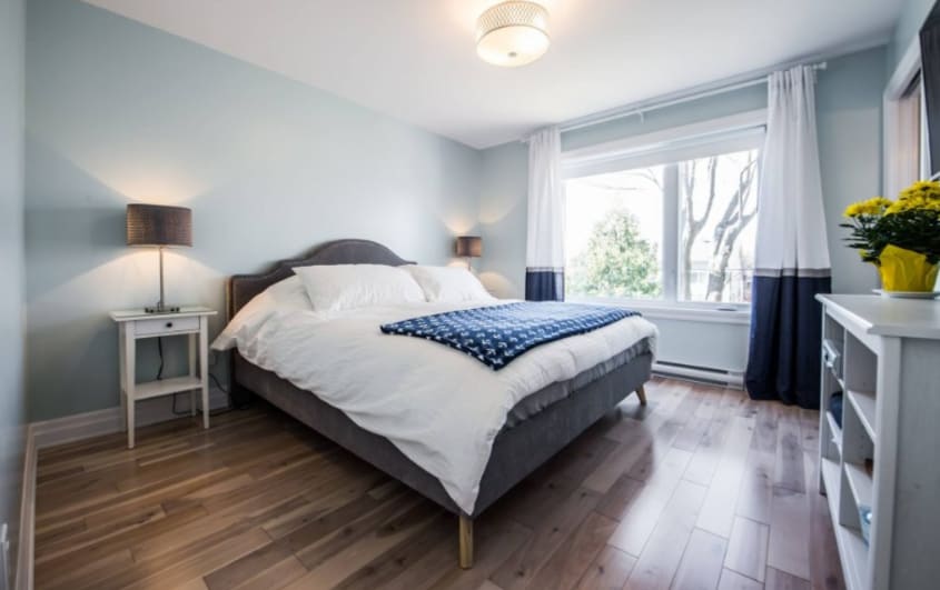 bedroom with blue walls and wood floor in home extension