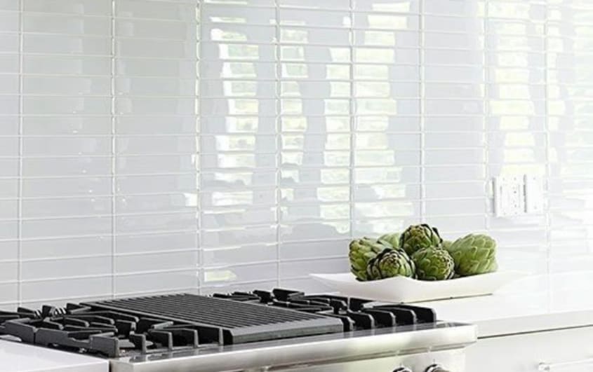 Kitchen white glass subway tile above gas stove