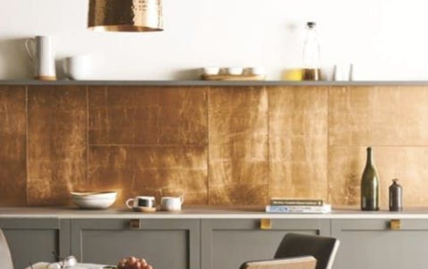 Modern kitchen with grey cabinets and copper style backsplash