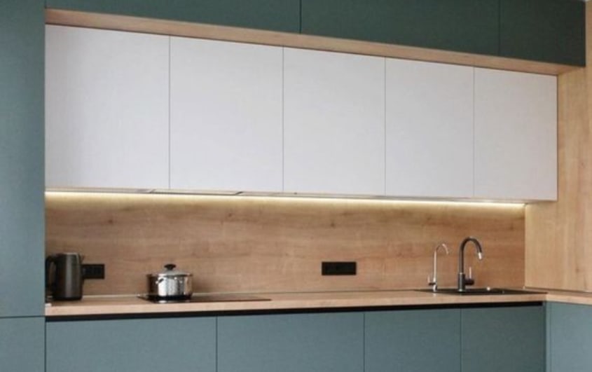 Kitchen with two-tone, white and sage green, cabinets and white oak backsplash