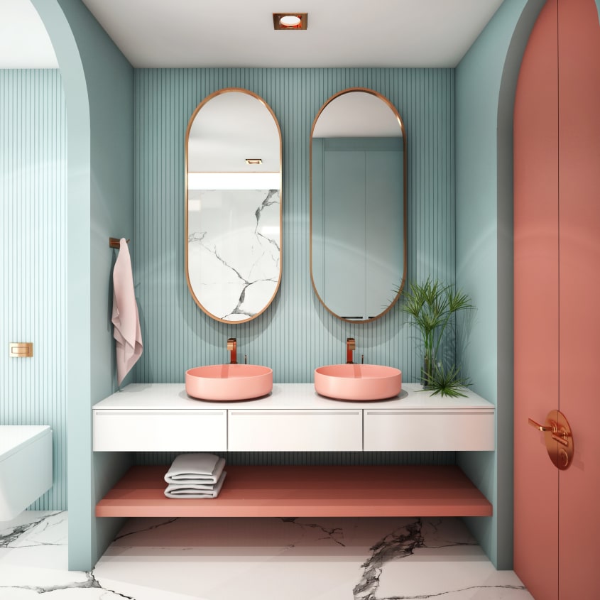 Dans une salle de bain avec arches murales, une alcôve à texture cannelée peinturée bleu aigue-marine, un meuble-lavabo blanc à deux vasques rondes couleur pêche, étagère suspendue et portes doubles d’un placard couleur terracotta. Miroirs ovales et plant