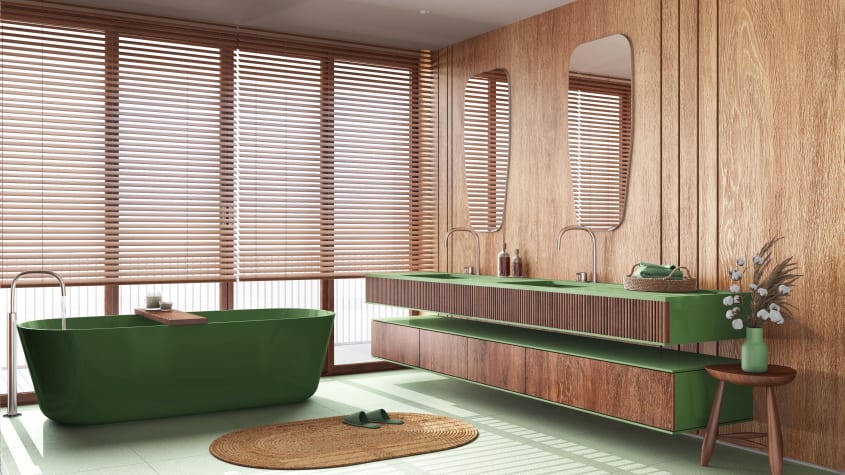 Salle de bain luxe de style japandi, avec accents de bois sur le mur, le panneau cannelé du meuble à deux lavabos encastrés, les armoires du meuble de rangement et le tabouret. Accent de couleur vert gazon sur le dessus des meubles et la baignoire autopor