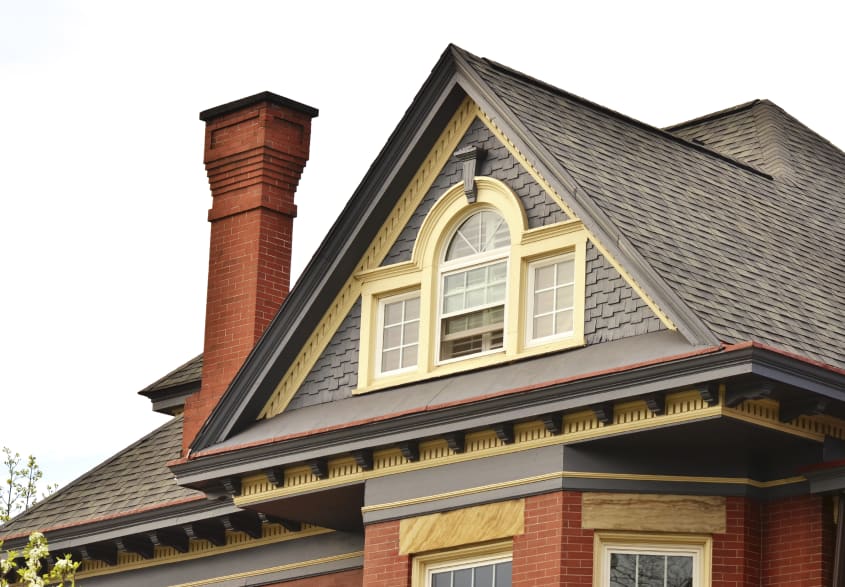 Asphalt shingles on gable roof with yellow mansard