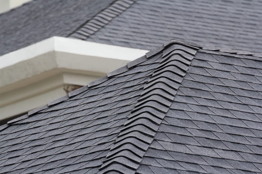 Dark asphalt shingles on a sloped roof