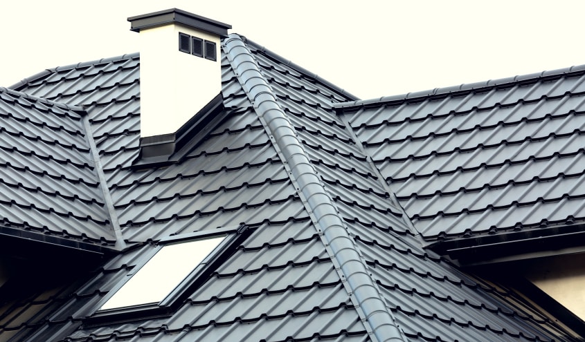 Sloped roof with skylight, covered with metal tiles