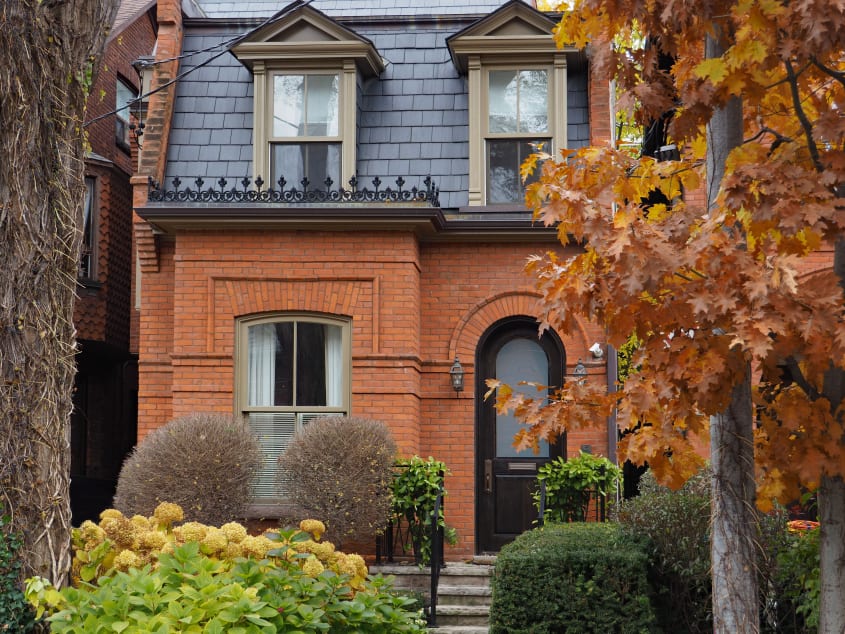 Old brick house with slate tiles and mansards