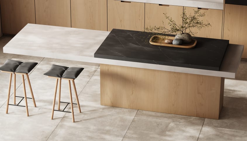 Vue sur le dessus d’un îlot de cuisine scandinave luxueuse incluant des accents de ciment et de marbre, tabourets en bois et accessoires en pierre
